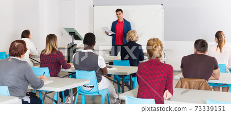 Male student answering at whiteboard 73339151