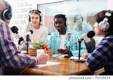 Scandal interview. Two outraged guests answering provocative questions of radio hosts during live radio show Scandal interview. Two outraged guests answering provocative questions of radio hosts during live radio show 73339454