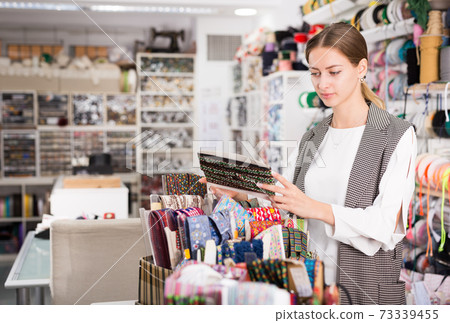 Woman choosing colorful ribbons Woman choosing colorful ribbons 73339455