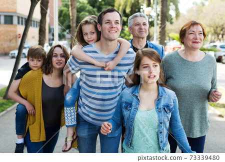 Cheerful males and females walking Cheerful males and females walking 73339480
