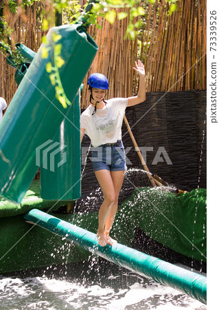 Girl passing horizontal bar with obstacles Girl passing horizontal bar with obstacles 73339526