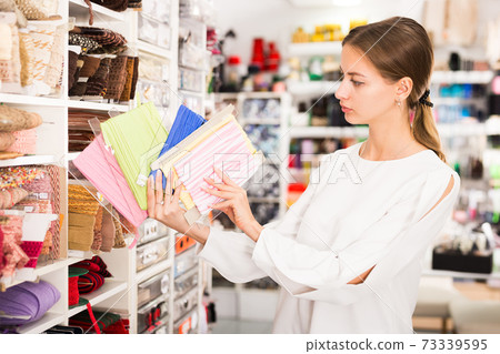 Woman choosing colorful ribbons Woman choosing colorful ribbons 73339595