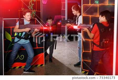 Kids playing laser tag on labyrinth Kids playing laser tag on labyrinth 73340173
