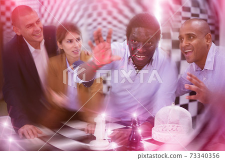 Four friends in quest room with special light effects Four friends in quest room with special light effects 73340356