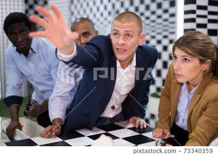 American man in quest room with colleagues 73340359