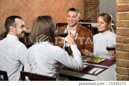 Group of people dining out merrily in country restaurant Group of people dining out merrily in country restaurant 73340375