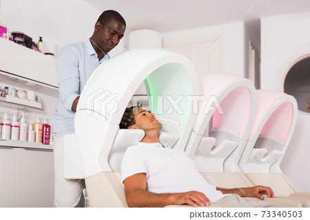 African American male washing hair to client 73340503