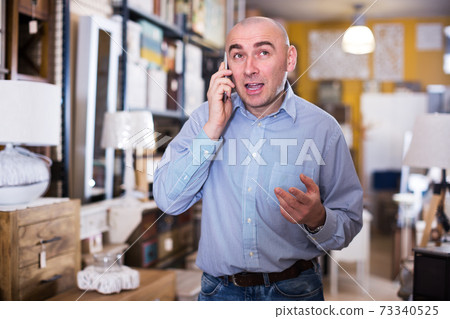 Businessman choosing home furniture 73340525