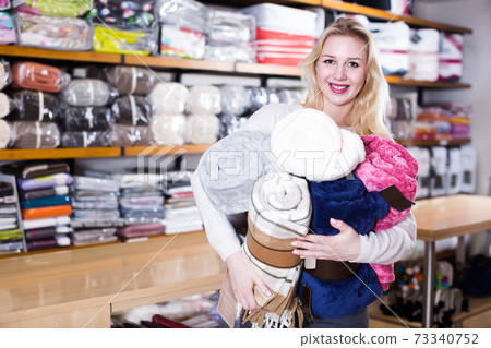 Young girl customer showing bought home textiles 73340752