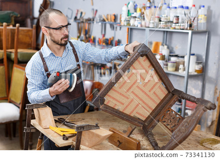 Craftsman repairing antique furniture Craftsman repairing antique furniture 73341130