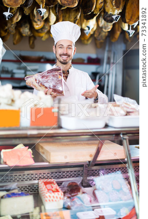 Seller offering piece of meat Seller offering piece of meat 73341892