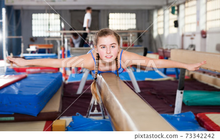 Teenage girl training gymnastics 73342242