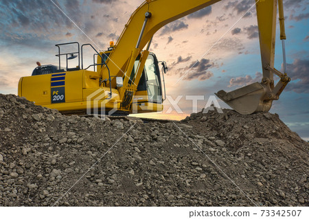 Beautiful sunset and excavator Beautiful sunset and excavator 73342507