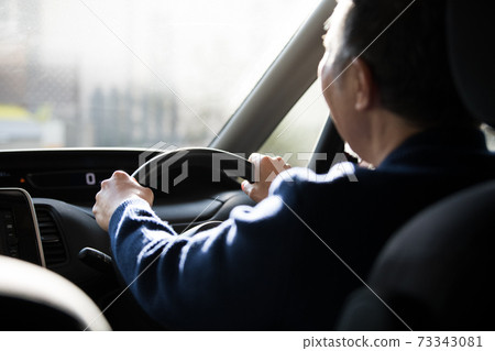 Image of senior men driving a car and men driving 73343081