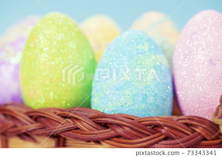 Colorful easter eggs on a stand on a table on a blue background 73343341