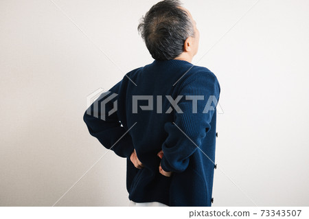 A man suffering from low back pain 73343507