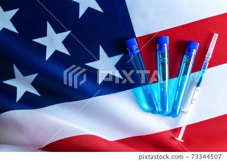 Disease outbreak. Medical syringe with needle for protection flu virus and coronavirus. Covid vaccine usa flag of america. Syringe, medical injection. 73344507