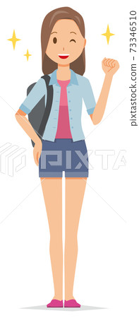 A young woman with a backpack is smiling and raising her fist A young woman with a backpack is smiling and raising her fist 73346510