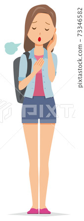 A young woman with a backpack is sighing A young woman with a backpack is sighing 73346582