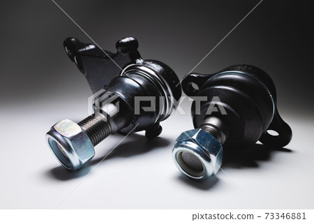 New set of spare parts for the front suspension of the SUV. 4 Ball joints in contrasting light on a black and white background 73346881