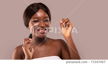 Oral Hygiene. Attractive African Woman Using Dental Floss And Smiling At Camera 73347407