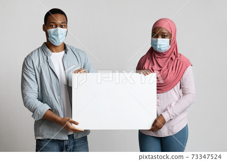 African american muslim family with blank placard 73347524