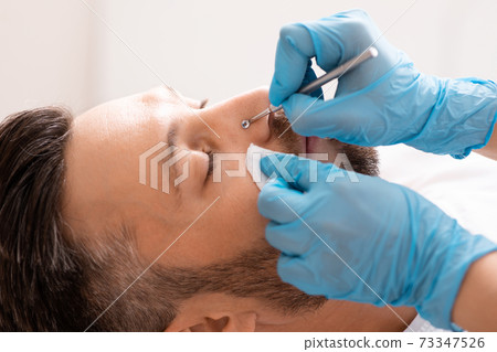 Middle-aged man having face cleansing treatment at beauty salon Middle-aged man having face cleansing treatment at beauty salon 73347526