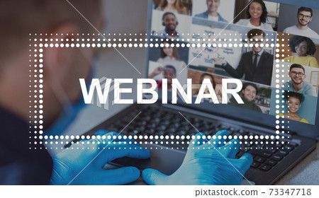 Doctor in face mask and protective gloves having webinar Doctor in face mask and protective gloves having webinar 73347718