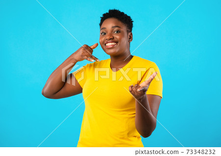 Plus-Size African Woman Gesturing Call Me Over Blue Background 73348232