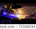frosted car glass. snow covered car windshield. view from inside the car on the night city 73348544