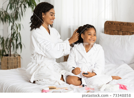 Cheerful Black Mother And Daughter In Bathrobes Having Beauty Day At Home Cheerful Black Mother And Daughter In Bathrobes Having Beauty Day At Home 73348858