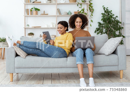 Modern work together at home and surfing on internet in free time Modern work together at home and surfing on internet in free time 73348860