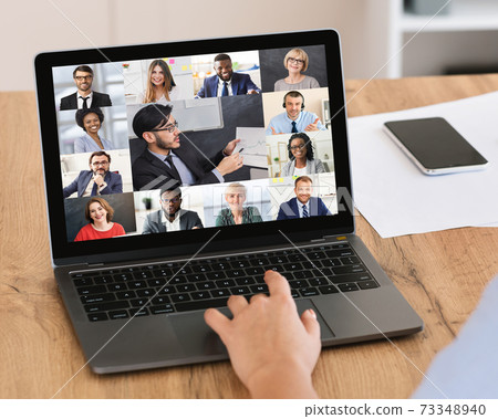 Unrecognizable businesswoman having online corporate meeting at laptop in office Unrecognizable businesswoman having online corporate meeting at laptop in office 73348940