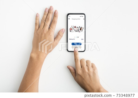 Female hands browsing online make up store Female hands browsing online make up store 73348977