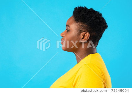 Profile Portrait Of Overweight African American Woman Over Blue Background 73349004