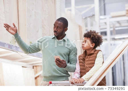 African Man Choosing Materials in Construction Store 73349291
