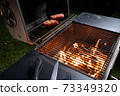 Meat on the grill, cooking in the open air in the evening 73349320