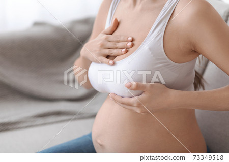 Breast Massage. Unrecognizable Pregnant Woman In Bra Massaging Her Chest At Home 73349518