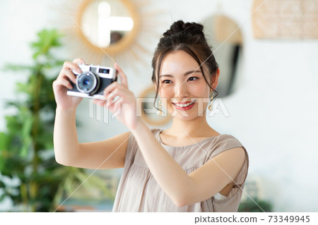 Beautiful woman with a camera Beautiful woman with a camera 73349945