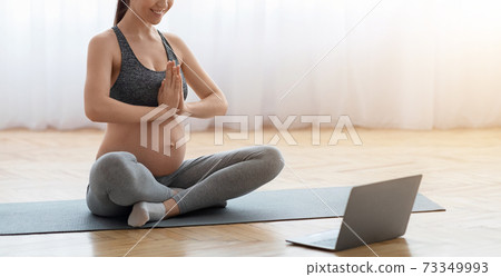 Online Yoga For Pregnant. Expecting Young Woman Training At Home With Laptop 73349993