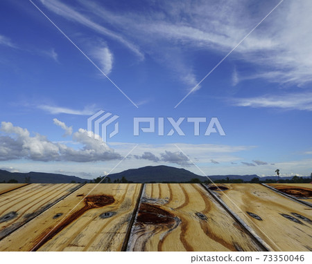 Empty wooden table on blue sky background. Mock up for your product display or montage. Empty wooden table on blue sky background. Mock up for your product display or montage. 73350046