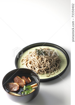 Photographed duck seiro soba with roasted duck meat, grilled green onions and trefoil on a white background Photographed duck seiro soba with roasted duck meat, grilled green onions and trefoil on a white background 73350402