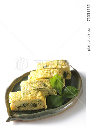Photographed soup stock rolled egg with trefoil on a white background 73351585