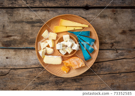 Top view of set cheese board on wooden background Top view of set cheese board on wooden background 73352585