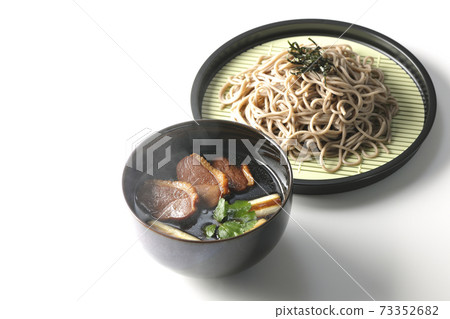 Photographed hot duck seiro soba with roasted duck meat, grilled green onions and trefoil on a white background Photographed hot duck seiro soba with roasted duck meat, grilled green onions and trefoil on a white background 73352682
