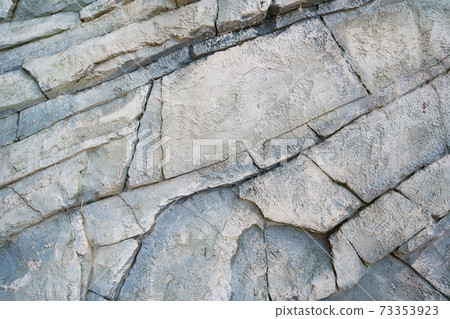 wall of stone bricks. background and texture of cobblestones. wall of stone bricks. background and texture of cobblestones. 73353923