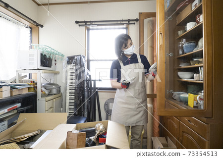 Workers cleaning up a messy room 73354513
