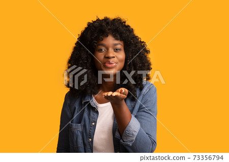 Beautiful african american lady sending flying kiss Beautiful african american lady sending flying kiss 73356794