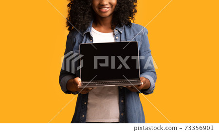 African american woman using laptop with empty screen, cropped 73356901