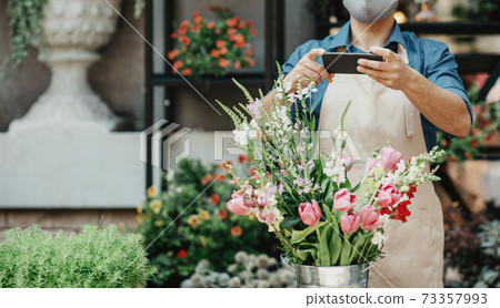 Fresh cut flowers, work of florist at flower shop and new normal Fresh cut flowers, work of florist at flower shop and new normal 73357993